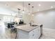 Bright kitchen features a granite island, stainless steel appliances, and opens to living area at 17847 Althea Blue Pl, Lutz, FL 33558