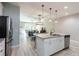 Bright and modern kitchen with stainless steel appliances and ample counter space, connecting living space at 17847 Althea Blue Pl, Lutz, FL 33558
