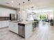 Open concept living area seamlessly connects a modern kitchen to a cozy living room at 17847 Althea Blue Pl, Lutz, FL 33558