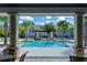 Community pool framed by palm trees and a clear blue sky at 17847 Althea Blue Pl, Lutz, FL 33558