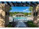Beautiful community pool area with a covered structure and lounge seating, perfect for relaxing in the sun at 17847 Althea Blue Pl, Lutz, FL 33558