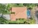 Overhead shot of the property highlighting the terracotta roof, screened pool, and beautiful backyard pond at 18002 Avalon Ln, Tampa, FL 33647