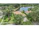 Gorgeous aerial view of the home, showcasing the pool, landscaping, and pond at 18002 Avalon Ln, Tampa, FL 33647