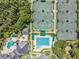 An aerial view shows tennis courts and a pool within a community setting at 18002 Avalon Ln, Tampa, FL 33647