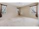 Spacious carpeted bedroom has a ceiling fan and large windows at 18002 Avalon Ln, Tampa, FL 33647