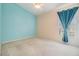 Bright bedroom with blue accent wall, neutral walls, white trim, and ceiling fan with a light at 18002 Avalon Ln, Tampa, FL 33647