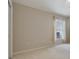 Bright bedroom with beige carpet, neutral walls and a window with sheer, decorative curtains at 18002 Avalon Ln, Tampa, FL 33647