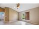 Bright bedroom with tile floors, neutral walls, vaulted ceiling and a window with a view of the outside at 18002 Avalon Ln, Tampa, FL 33647
