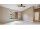 Bright bedroom with tile floors, neutral walls, vaulted ceiling and a window with a view of the outside at 18002 Avalon Ln, Tampa, FL 33647