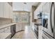 Bright kitchen with stainless steel appliances and tiled flooring at 18002 Avalon Ln, Tampa, FL 33647