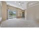 Bright living room with sliding glass doors leading to the outdoor pool area at 18002 Avalon Ln, Tampa, FL 33647
