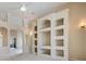 Open-concept living room featuring custom built-ins and arched doorways at 18002 Avalon Ln, Tampa, FL 33647
