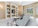 Cozy living room boasting built-in shelving, recessed lighting, and sliding glass doors at 18002 Avalon Ln, Tampa, FL 33647