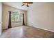 Bright living room with tile floors, neutral walls, and a large window with a half-moon window above at 18002 Avalon Ln, Tampa, FL 33647