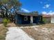 Charming one-story home featuring a quaint porch and a driveway, set under a bright, sunny sky at 1931 44Th S St, St Petersburg, FL 33711