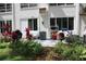 Backyard patio with tropical landscaping features a grill, seating and an air conditioner at 2020 World Parkway Blvd # 12, Clearwater, FL 33763