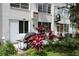 Backyard patio with tropical landscaping features a grill, seating, and air conditioning unit at 2020 World Parkway Blvd # 12, Clearwater, FL 33763