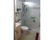 Updated bathroom with tiled floor, glass-enclosed shower, and a bright vanity at 2020 World Parkway Blvd # 12, Clearwater, FL 33763