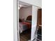 A bedroom with hardwood floors, decorative bedding, and closet at 2020 World Parkway Blvd # 12, Clearwater, FL 33763