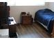 The bedroom has hardwood floors and an assortment of furniture and decor at 2020 World Parkway Blvd # 12, Clearwater, FL 33763