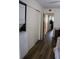 Hallway featuring hardwood floors, stacked washer and dryer unit, and ample closet space at 2020 World Parkway Blvd # 12, Clearwater, FL 33763