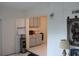 Galley kitchen featuring ample storage cabinets and countertop space, with white tile flooring at 2020 World Parkway Blvd # 12, Clearwater, FL 33763