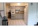 Functional kitchen features updated appliances, neutral cabinets, and ample countertop space at 2020 World Parkway Blvd # 12, Clearwater, FL 33763