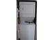 Close-up shot of the laundry unit with a stacked washer and dryer at 2020 World Parkway Blvd # 12, Clearwater, FL 33763