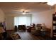 Well-lit living room featuring hardwood floors, ceiling fan, entertainment center and comfortable seating at 2020 World Parkway Blvd # 12, Clearwater, FL 33763