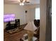 Cozy living room featuring a ceiling fan, television, and wood-look flooring at 2020 World Parkway Blvd # 12, Clearwater, FL 33763