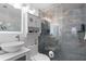 Modern bathroom featuring blue accent tiles, a frameless glass shower, and a stylish vessel sink at 219 4Th N Ave # 201, St Petersburg, FL 33701