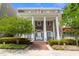Elegant red brick home featuring a covered entryway supported by grand white pillars and beautiful landscaping at 219 4Th N Ave # 201, St Petersburg, FL 33701