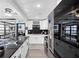 Modern kitchen features sleek white cabinets, stainless steel appliances, and a black marble countertop island at 219 4Th N Ave # 201, St Petersburg, FL 33701