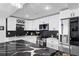 Modern kitchen features sleek white cabinets, stainless steel appliances, and a black marble countertop island at 219 4Th N Ave # 201, St Petersburg, FL 33701