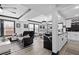 An open-concept living room with high ceilings, hardwood floors, a ceiling fan, and large windows at 219 4Th N Ave # 201, St Petersburg, FL 33701