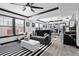 Bright living room featuring a large window, ceiling fan, and striped rug providing a sleek and modern aesthetic at 219 4Th N Ave # 201, St Petersburg, FL 33701