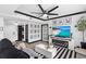 Inviting living space featuring a comfortable sofa, modern furnishings, a fan and a television set for relaxing at 219 4Th N Ave # 201, St Petersburg, FL 33701