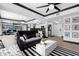 Bright and open floor plan showcasing a living room with modern furnishings and kitchen in neutral black and white tones at 219 4Th N Ave # 201, St Petersburg, FL 33701