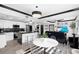 Contemporary living space with a kitchen island, modern lighting and sleek, clear dining set in a neutral color palette at 219 4Th N Ave # 201, St Petersburg, FL 33701