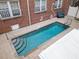 A private pool surrounded by brick paving and a brick building, offering a peaceful and refreshing outdoor space at 219 4Th N Ave # 201, St Petersburg, FL 33701