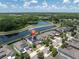 Beautiful aerial view of a waterfront home featuring solar panels and a screened-in pool at 2641 Whittler Br, Odessa, FL 33556