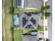 Aerial view of a home with solar panels and a screened-in pool in a residential neighborhood at 2641 Whittler Br, Odessa, FL 33556