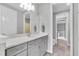 Bathroom featuring gray cabinets, white countertop, and a view into an adjacent bedroom at 2641 Whittler Br, Odessa, FL 33556