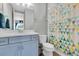 Bathroom featuring a blue vanity with white countertops and a shower with a colorful patterned curtain at 2641 Whittler Br, Odessa, FL 33556