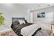 Modern bedroom with textured wall, gray headboard and bedding, and an abstract art piece at 2641 Whittler Br, Odessa, FL 33556