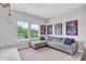 Bonus room featuring modern seating and a window with a backyard view and artwork at 2641 Whittler Br, Odessa, FL 33556