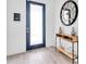 Modern entryway with a decorative mirror and console table at 2641 Whittler Br, Odessa, FL 33556