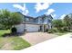 Beautiful two-story home with a three-car garage, brick driveway, and professionally landscaped yard at 2641 Whittler Br, Odessa, FL 33556