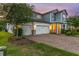 Charming two-story home with a three-car garage, beautiful brick driveway, and twilight sky at 2641 Whittler Br, Odessa, FL 33556