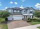 Charming two-story home with a three-car garage, brick driveway, and professionally landscaped yard at 2641 Whittler Br, Odessa, FL 33556